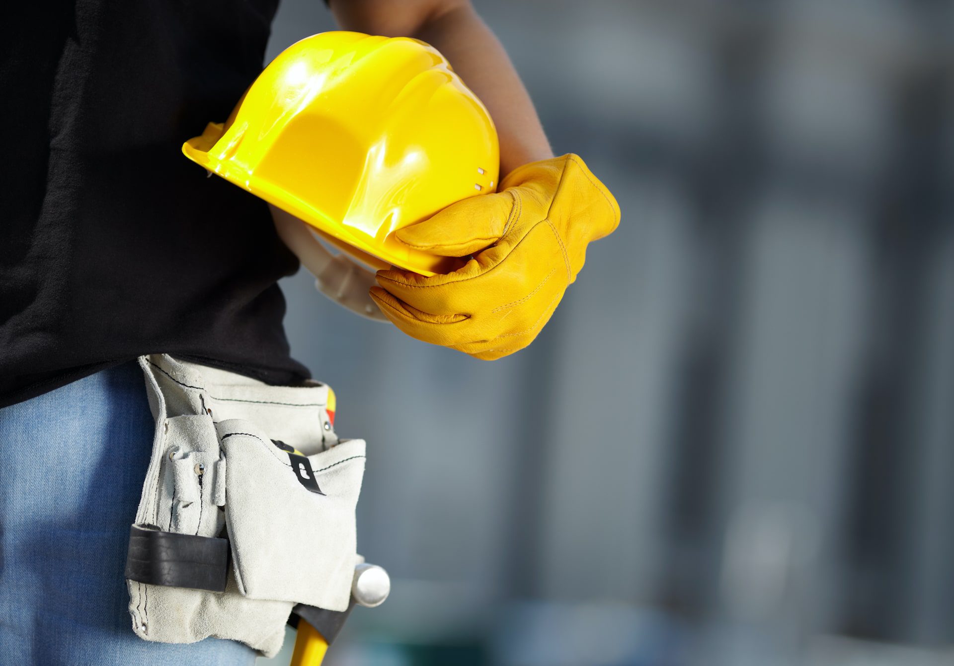 Image of roofing contractor with tool belt and hard hat.