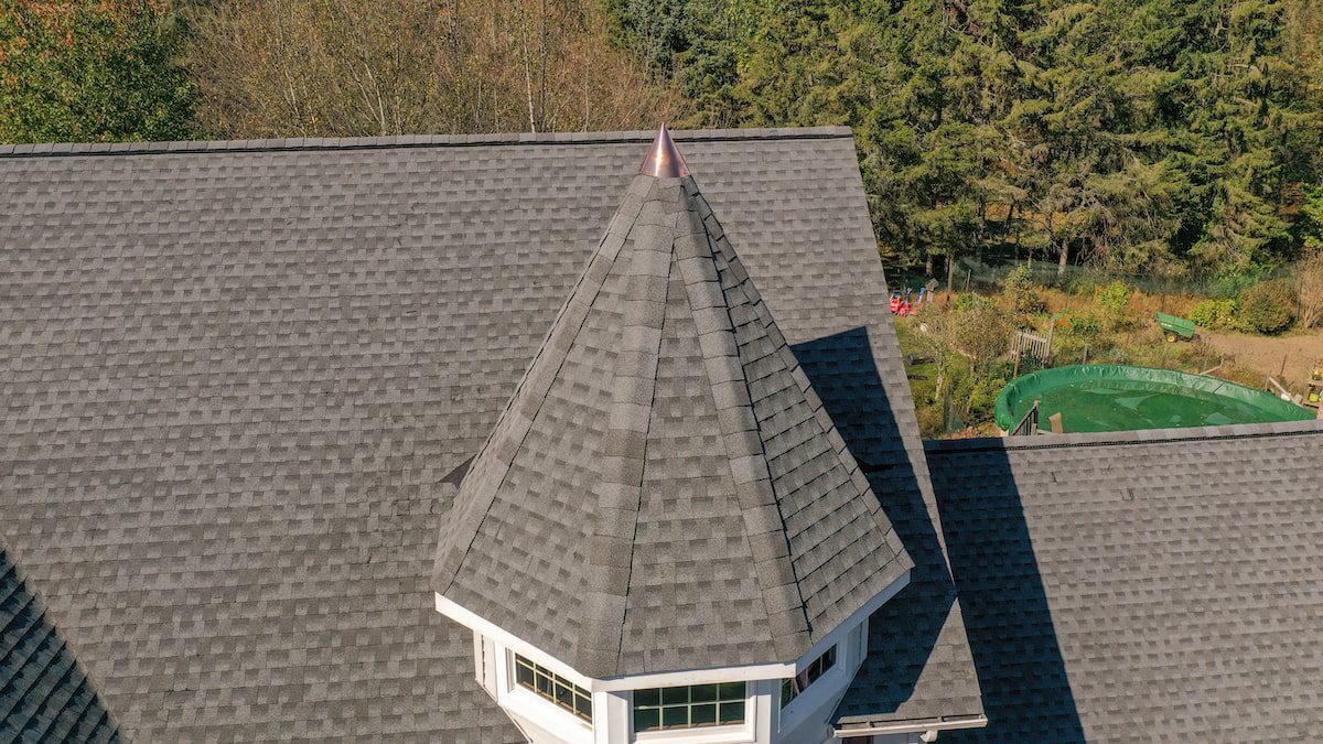 image009(1) Image of a home in NJ with copper flashing on the turret of a roof.
