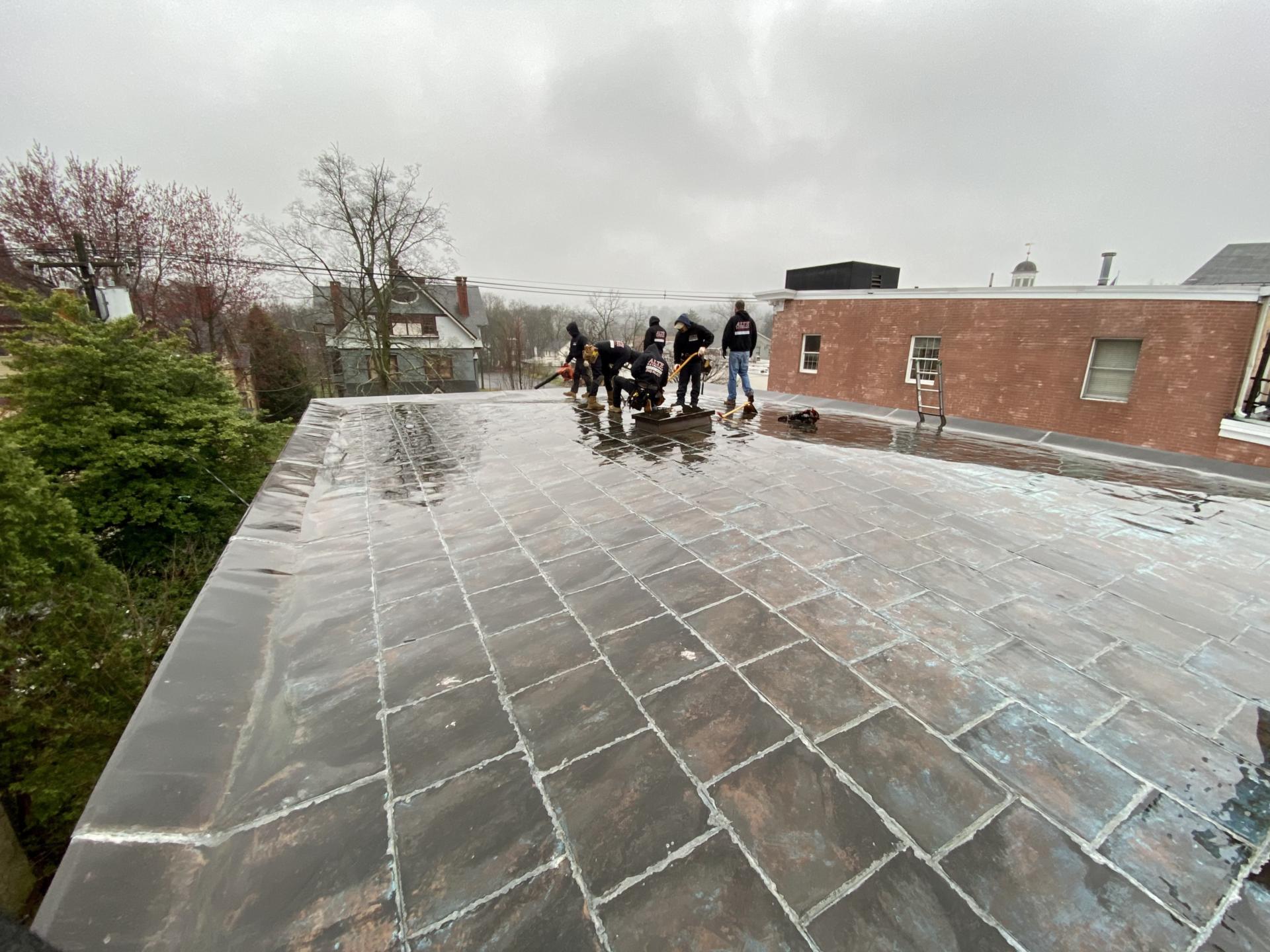 image2-min Image of the Alte Exteriors LLC team installing a flat roof.
